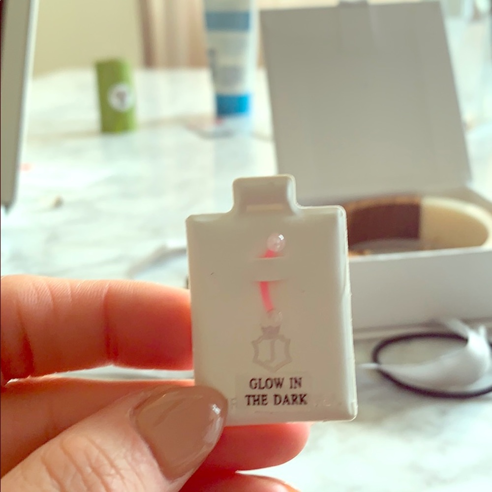 Neon pink glow in the dark bellybutton bar